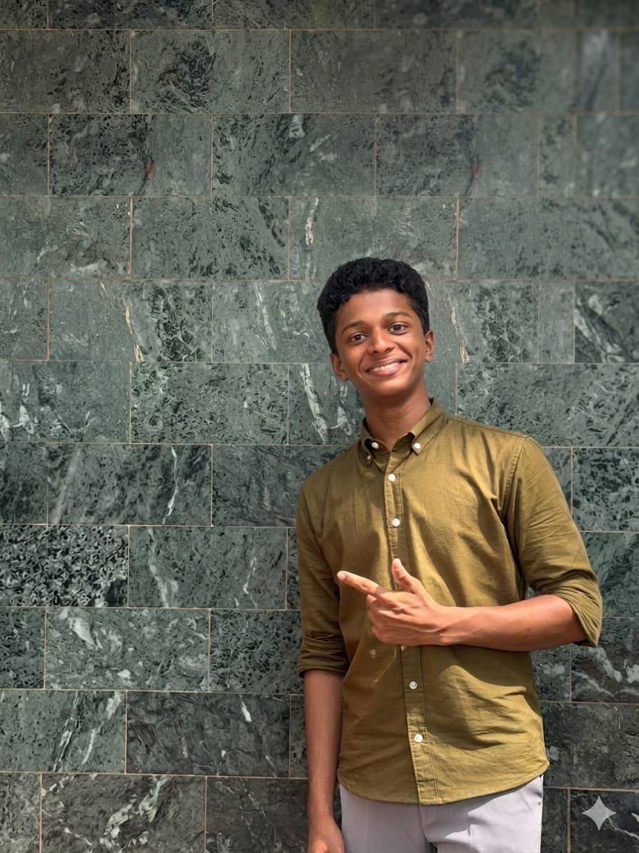 Aflah smiling beside a stone wall